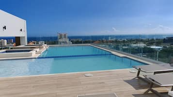 Outdoor pool, pool umbrellas, sun loungers