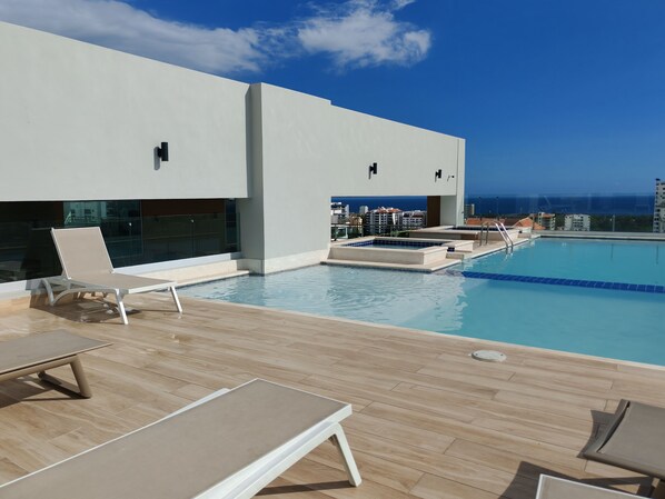 Outdoor pool, pool umbrellas, sun loungers