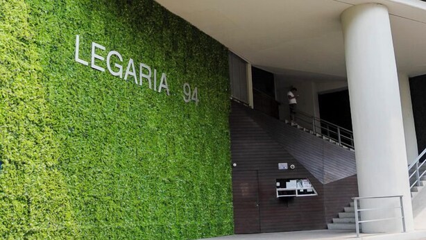 A modern building with a green wall and the name "LEGARIA 94" on it. - Chic Condo with Gym & Private Roof (Mexico City)