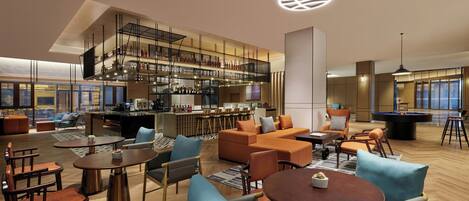 Un moderno vestíbulo de hotel con zona de bar, espacios para sentarse y mesa de billar.