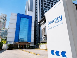 A modern building with a prominent blue glass facade and a sign for 'Journey Hub Bangkok Sukhumvit 26' indicating a hotel or business center. - Journeyhub Sukhumvit 26 Bangkok (Bangkok)