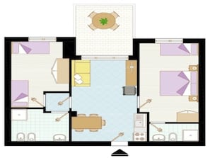Un appartement de deux chambres comprenant un coin repas, une cuisine et un petit balcon.