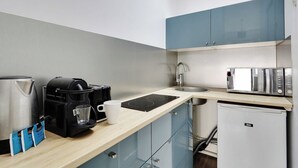 A compact kitchenette with a coffee maker, a kettle, a microwave, and a small refrigerator. - Magnificent studio - 2P - Near Bastille (Paris)