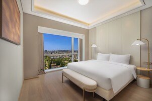 Elite Suite, Multiple Beds, Kitchenette, City View | Living area | 55-inch LCD TV with cable channels