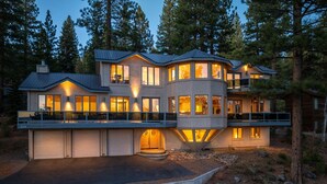 A modern multi-story house with a garage, large windows, and a balcony. - 90s Tahoe Time Capsule (Incline Village)