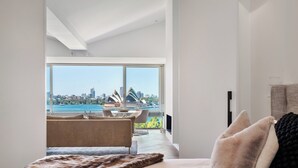 A modern hotel room with a large window offering a view of the Sydney Opera House and harbor. - 'Harbourview II' – Unmatched Views of the Iconic Opera House & Harbour Bridge! (Kirribilli)