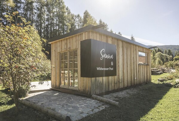 Una cabaña de madera con un letrero que dice "Saund Wildwasser Pool".