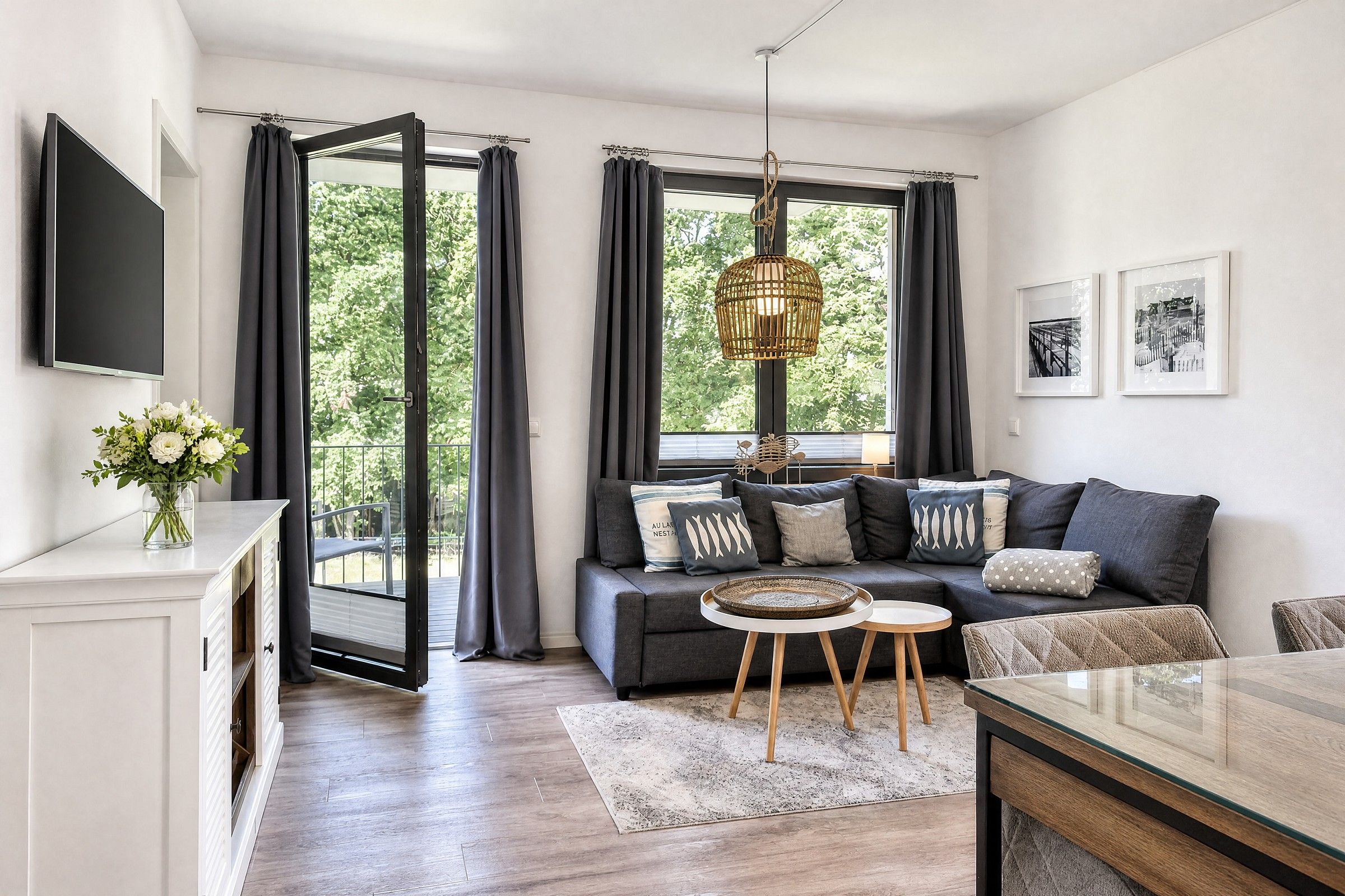 A modern living room with a sofa, coffee table, and a TV mounted on the wall.