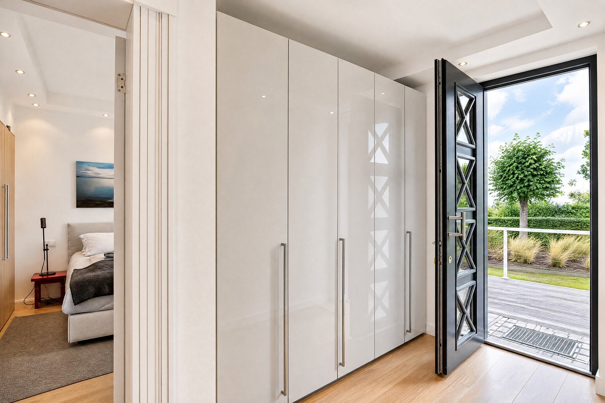 A modern interior with a large wardrobe, a bed, and a view of the outdoors.