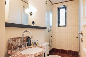 A bathroom with a marble sink, a mirror, a shower, and a window. - Liiiving in Porto - Casa Duque Apt I (Porto)