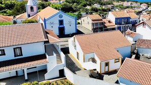 A coastal village with traditional architecture, including a church with a bell tower and a building labeled 'MATRIZ DE S. PEDRO'. - Casa da Gente T2 by PontaNegraAzores (Praia da Vitória)