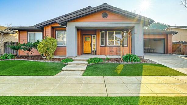 A modern two-story house with a front porch, a garage, and a well-maintained lawn. - 26 Mi to Fresno: Pet-friendly Home in Reedley! (Reedley)