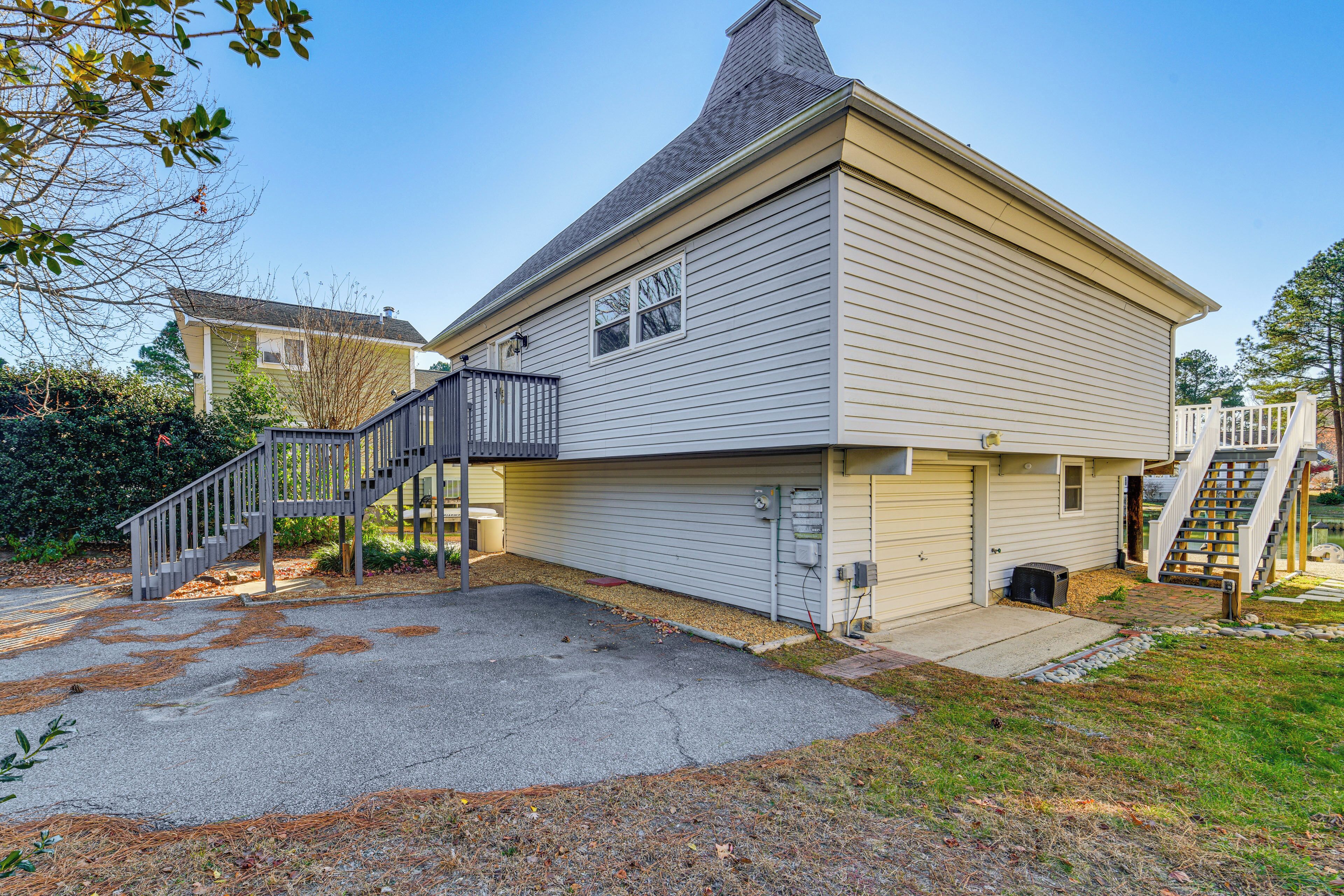 A two-story house with a garage, a covered front porch, and a staircase leading to the second floor.