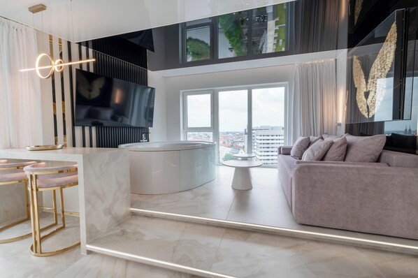 City appartement, balkon | Woonruimte | Een 37-inch flatscreentelevisie met satellietzenders