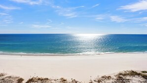 A beach with a clear sky and calm sea.