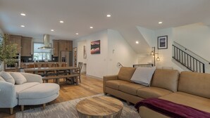 A modern living room with a sofa, a coffee table, and a dining area with a table and chairs. - cabin, hot tub! 3rd night free stay before 9/8/26 (Government Camp)