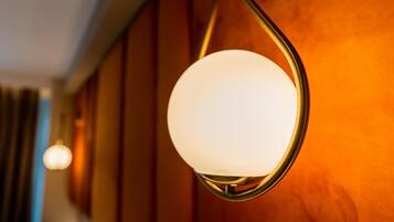 A wall-mounted light fixture with a spherical glass shade.