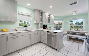 Enjoy cooking in this well-lit kitchen with an oven, stainless steel dishwasher, and ample workspace.
