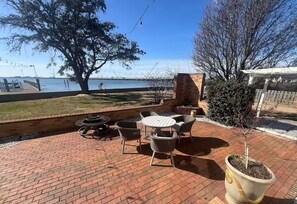 Relax by the water with a warm fire and comfortable seating.