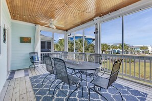 Enjoy dining or meeting in this serene outdoor space with a round table and comfortable seating.