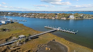 An aerial view of a marina with docks and boats, surrounded by grassy areas and residential buildings. - Birds' Nest -oceanfront condo in Dunescape Villas with beautiful views (Atlantic Beach)
