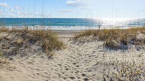A sandy beach with sparse vegetation and a clear view of the ocean. - Birds' Nest -oceanfront condo in Dunescape Villas with beautiful views (Atlantic Beach)