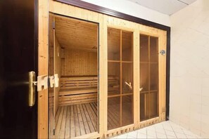 A wooden sauna with a sliding glass door, a metal handle, and a tiled floor. - Vogue | Lake City Tower JLT near Marina | JBR (Dubai)
