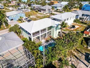 A residential area with houses, a swimming pool, and a large building with a balcony.