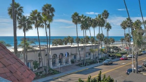 A coastal hotel with a view of the ocean and a pier. - South Pacific Walk to Beach! (Oceanside)