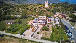 Una zona residencial en una ladera con casas, una carretera y una torre.