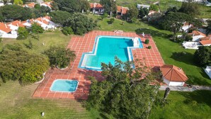 An aerial view of a residential area with a large rectangular swimming pool surrounded by a red-tiled deck. - #266 Luxurious Villa Bellagio by Home Holidays (Albufeira)