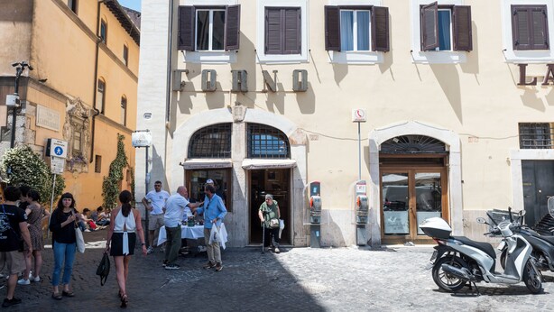 A street scene with a building labeled "FORNO" and a parked scooter. - Campo De Fiori Large Family Apartment (Rome)