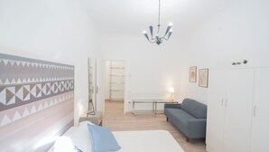 A hotel room with a bed, a sofa, a desk, and a wardrobe. - Lovely Apartment In Hip And Vibrant Pigneto (Rome)