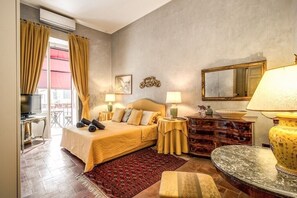 A hotel room with a bed, bedside tables, a dresser, a mirror, and a television. - Wonderful Apartment With Balcony In Piazza Margana (Rome)