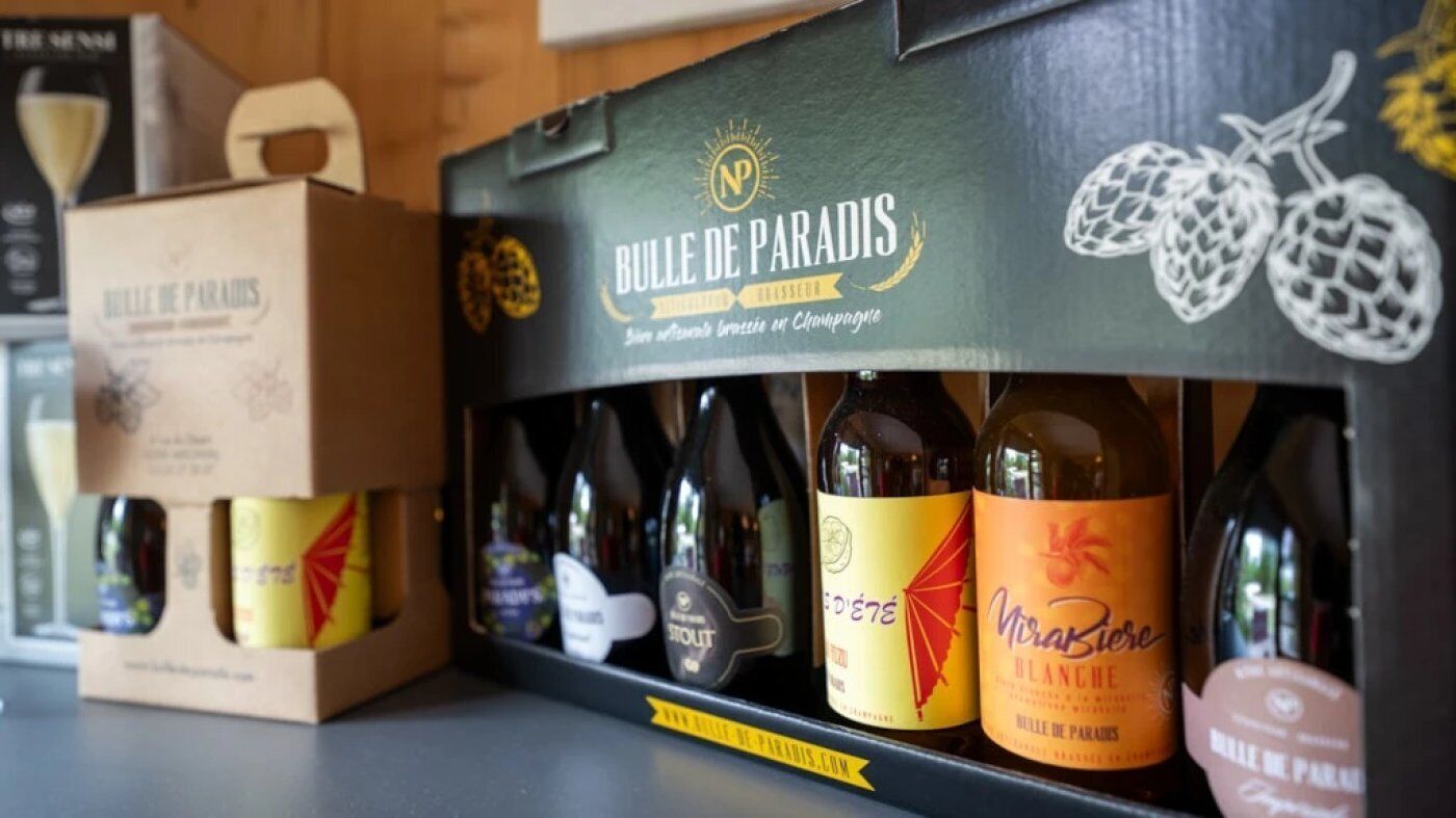 A wine box labeled "Bulle de Paradis" with various bottles of wine inside.