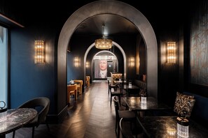 A modern interior with a central arched corridor, seating areas, and ambient lighting. - The Goethe Hotel - Small Luxury Hotels of the World (Rome)