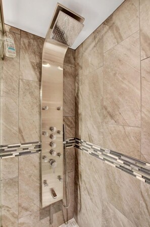 Enjoy a refreshing shower experience with a sleek showerhead and multiple controls.