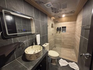 A modern bathroom with a marble sink, a toilet, and a shower area. - River Paradise Cabin with Private Jacuzzi (Provincia de Alajuela)