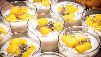 A selection of dessert bowls with mango chunks and chia seeds.