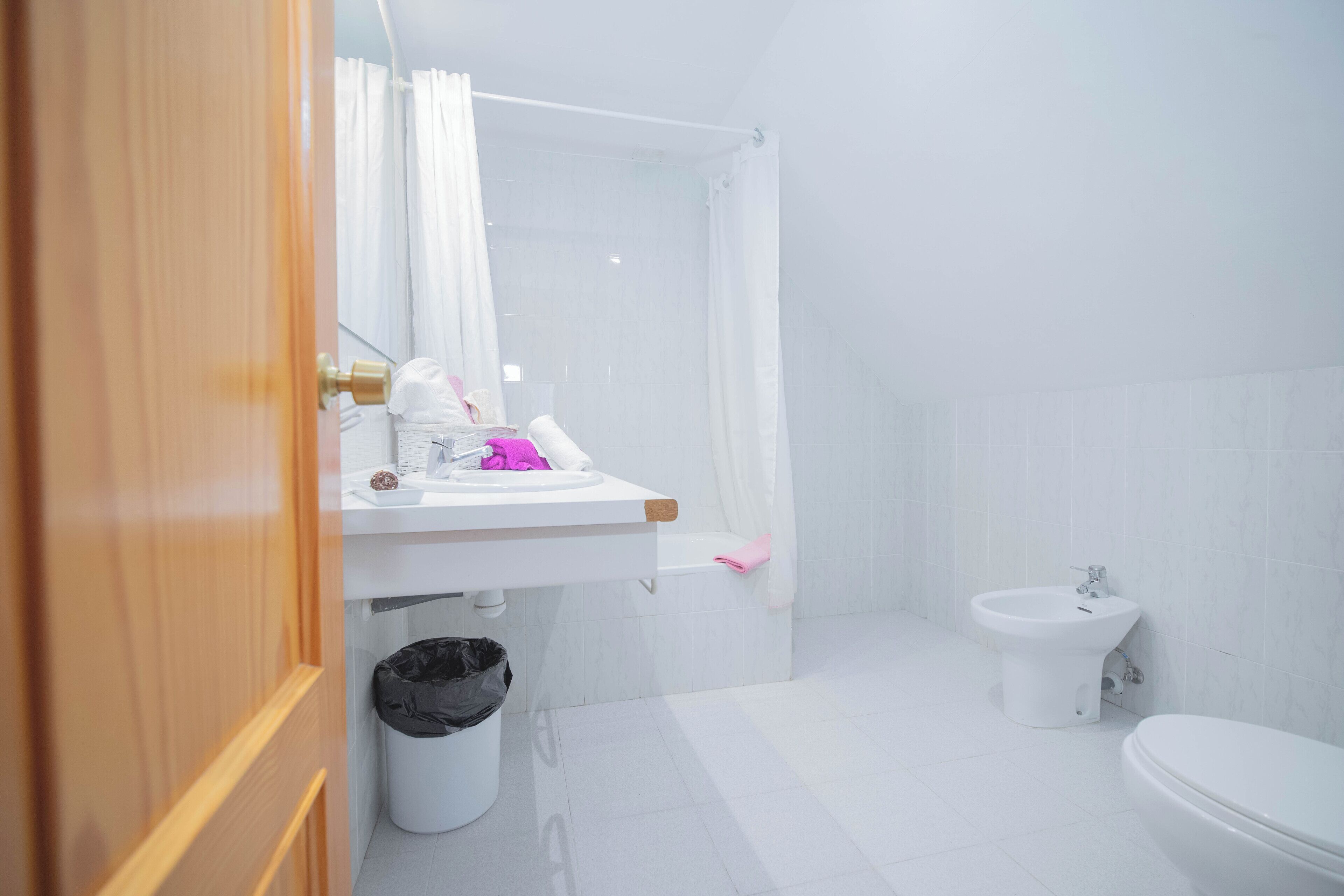 A bathroom with a sink, toilet, and shower.