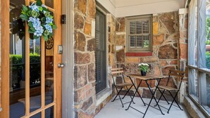 A stone exterior wall with a window and a door. - This is Your Home Away From Home! Warm & Comfy 2BD (Fort Worth)