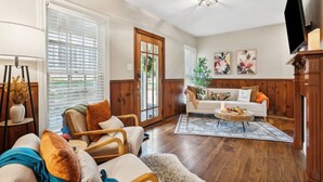 A living room with a sofa, armchairs, a coffee table, and a TV. - This is Your Home Away From Home! Warm & Comfy 2BD (Fort Worth)