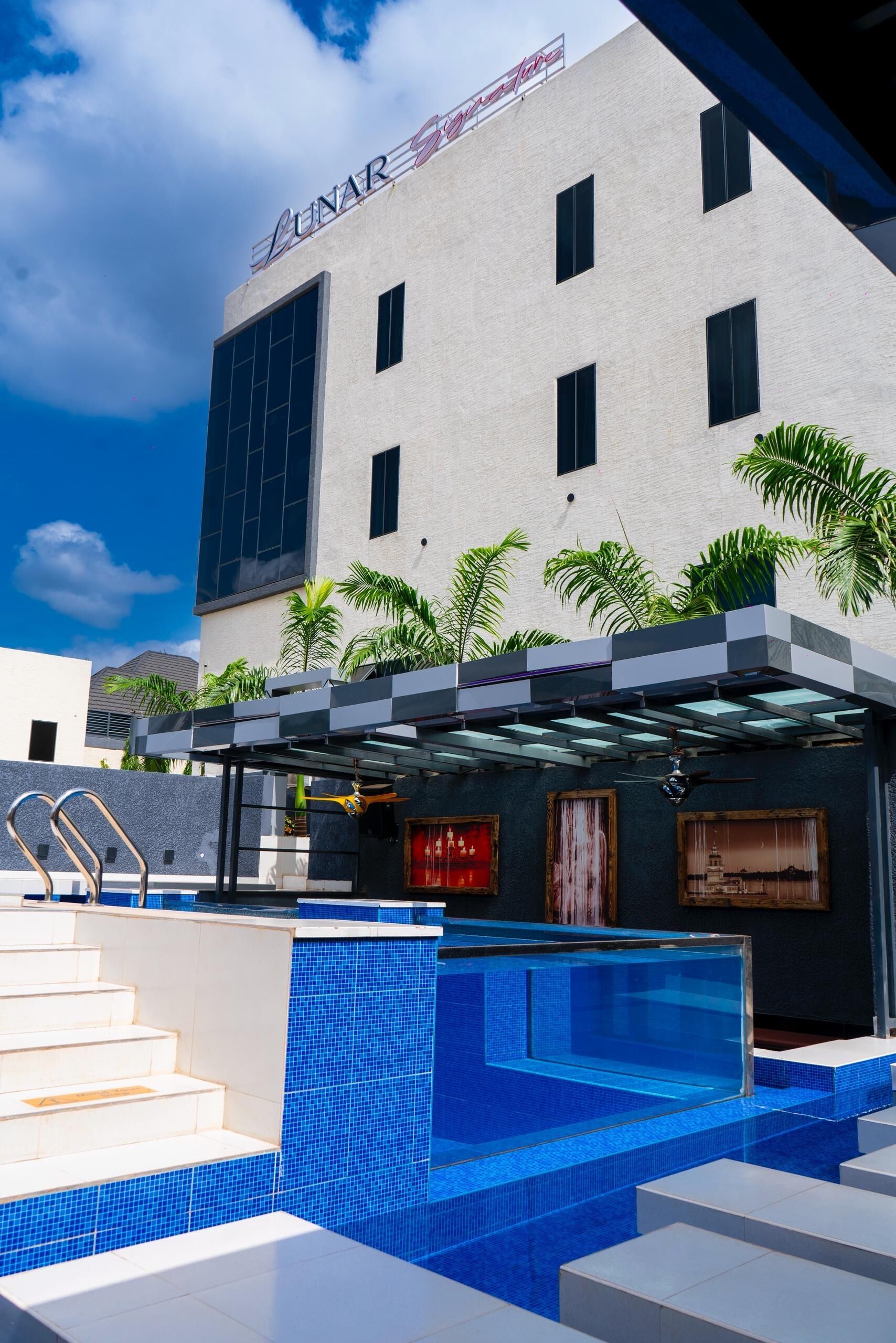 A hotel named 'LUNAR' with a pool area featuring blue tiles and steps leading into the water.