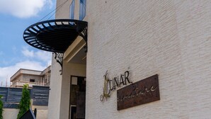 A building with a sign reading "LUNAR" and a covered entrance. - Lunar Signature Hotel & Suites  (Enugu)