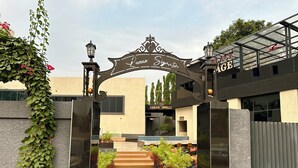 A gated entrance with a sign reading "Lunar Signature" and a building labeled "Lunar Grill". - Lunar Signature Hotel & Suites  (Enugu)