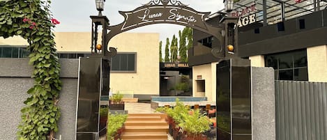 A gated entrance with a sign reading "Lunar Signature" and a building labeled "Lunar Grill".