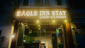 A building with a sign for "Eagle Inn Stay Luxury A/C Rooms" at night. - Eagle Stay Inn (Kanchipuram)