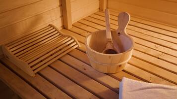 A wooden sauna bench with a wooden bowl and a ladle.