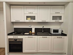 Fridge, stovetop, coffee/tea maker, cookware/dishes/utensils