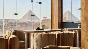 A modern interior with a view of a pyramid. - Crown Pyramids View Hotel (Giza)